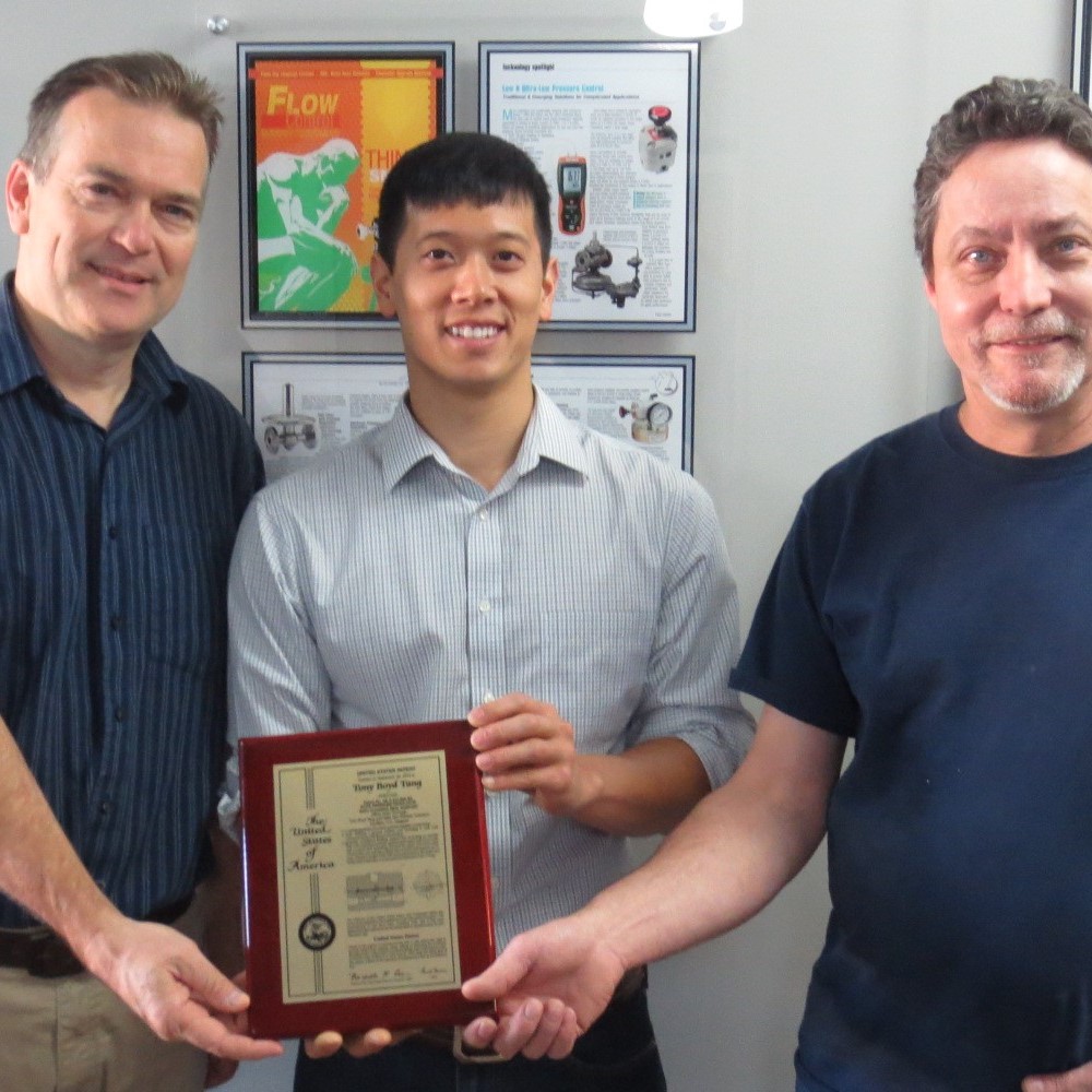 Jeff Jennings, left, Tony Tang, middle, and Keith Roberts with Zero Flow patent